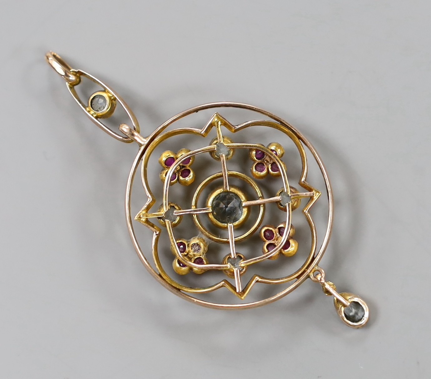 An Edwardian yellow metal, aquamarine, ruby and seed pearl set drop pendant, overall 55mm, gross weight 4.2 grams.